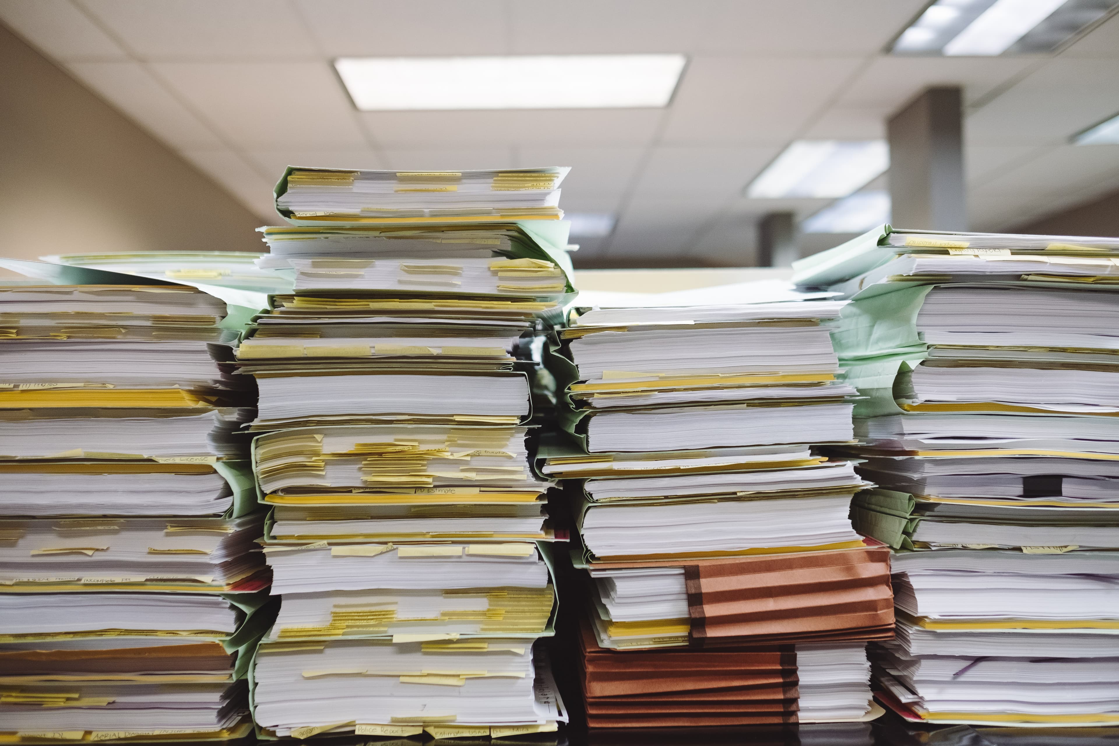 A stack of books, binders, and folders